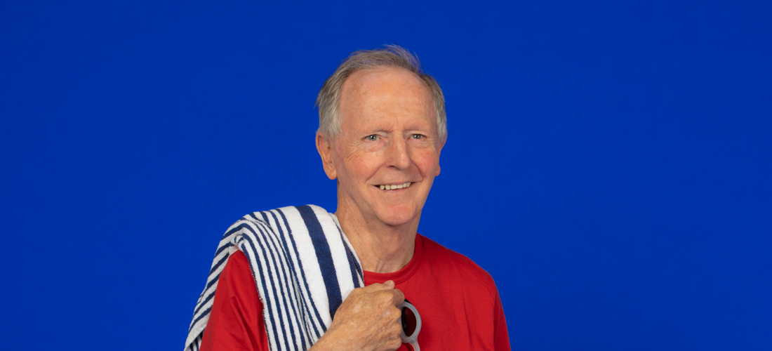 Image of older man with a swimming towel and goggles