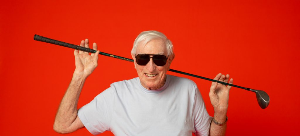 Image of senior man with a pair of sunglasses and a golf stick