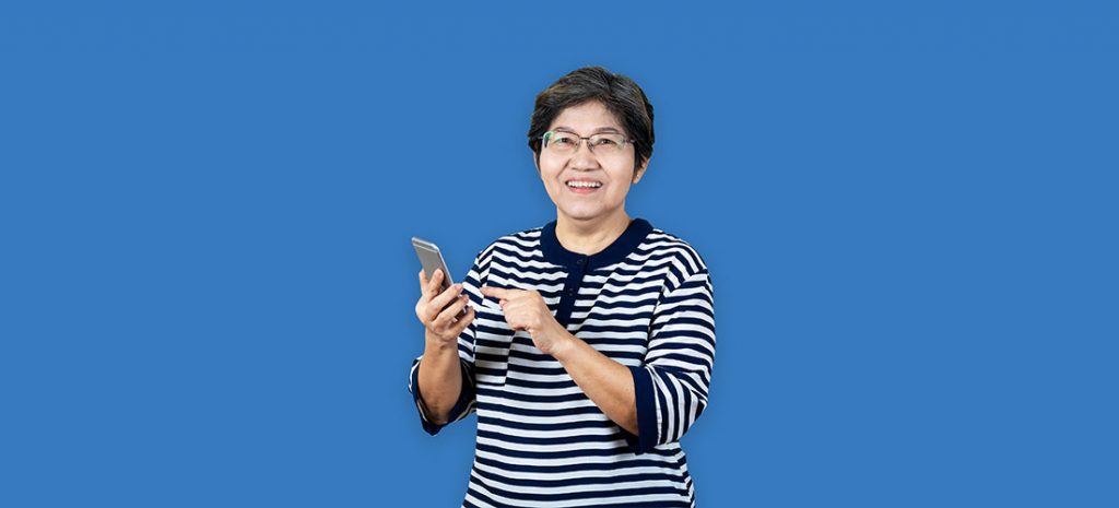 Asian lady with a mobile phone on a blue background